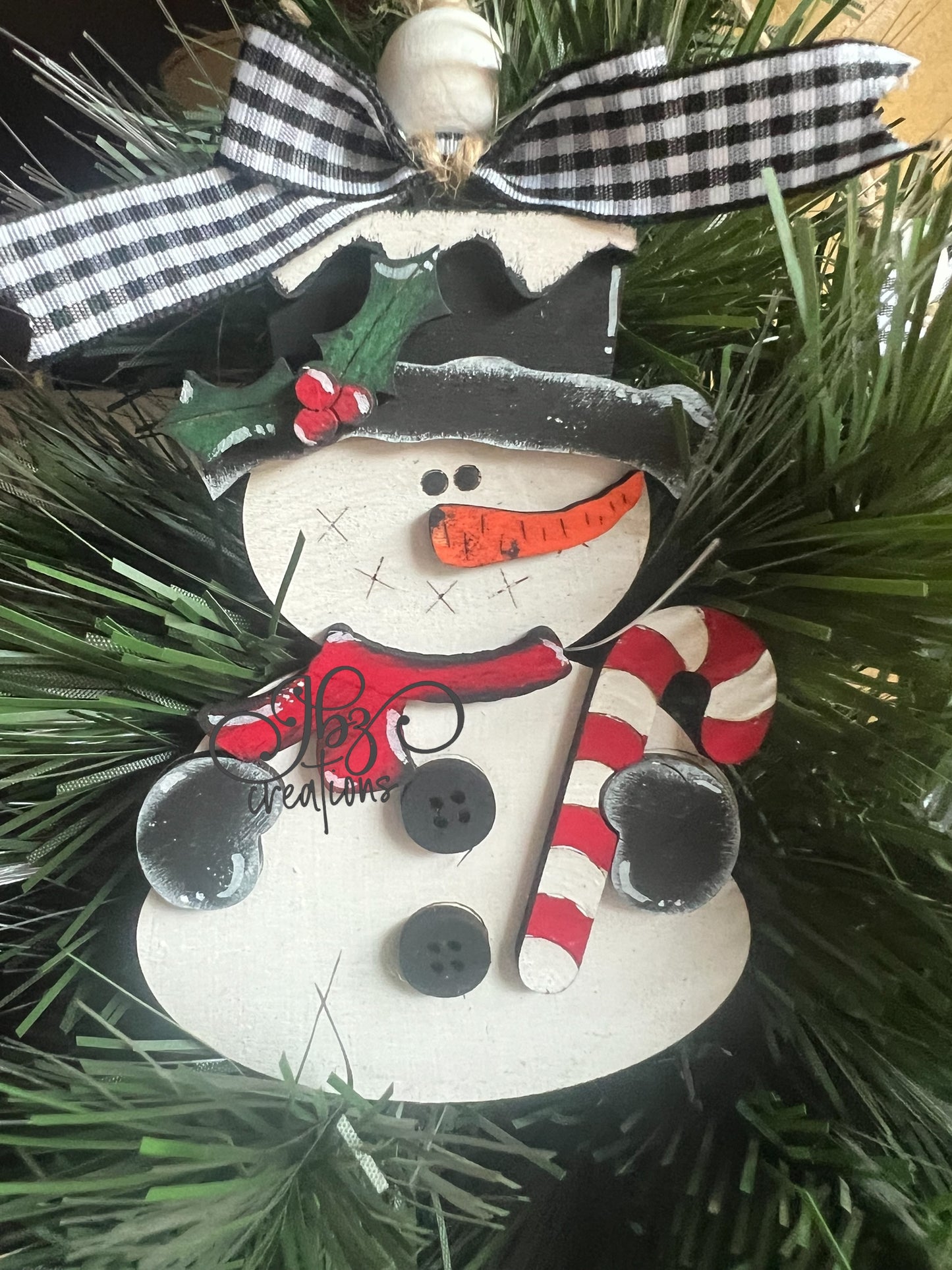 Snowman Holding a Candy Cane Christmas Tree Ornament