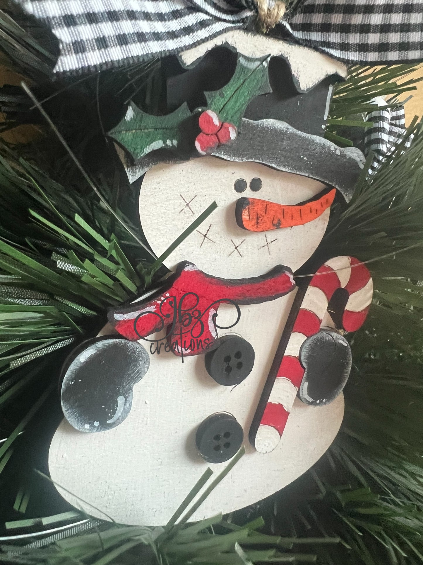 Snowman Holding a Candy Cane Christmas Tree Ornament